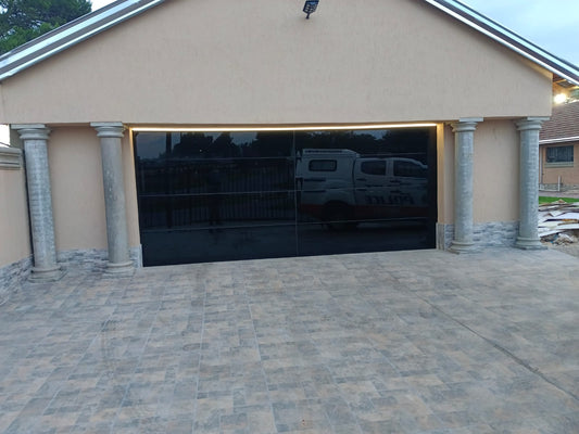 Luxury Frameless Black Glass Garage Door Installed in Gauteng