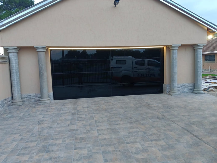 Luxury Frameless Black Glass Garage Door Installed in Gauteng